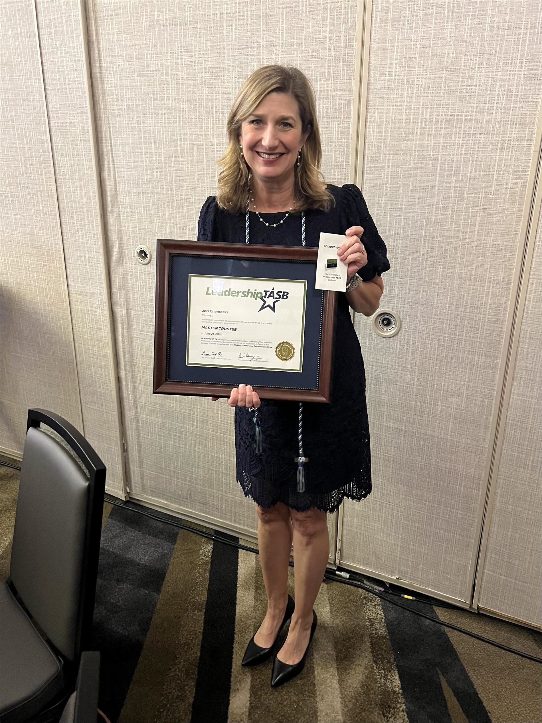 Image of Trustee Chambers with certificate and pin.